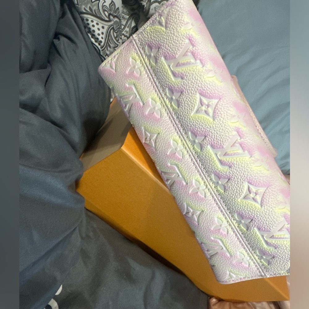 Louis Vuitton on the go pm.  Pink and yellow